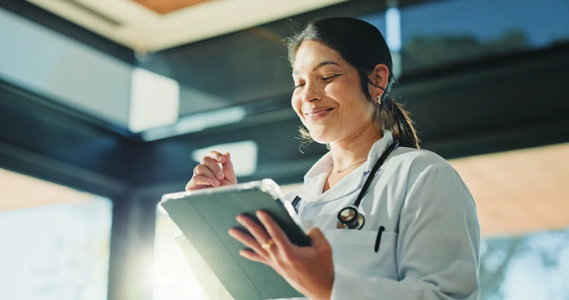A doctor reviewing information on a tablet